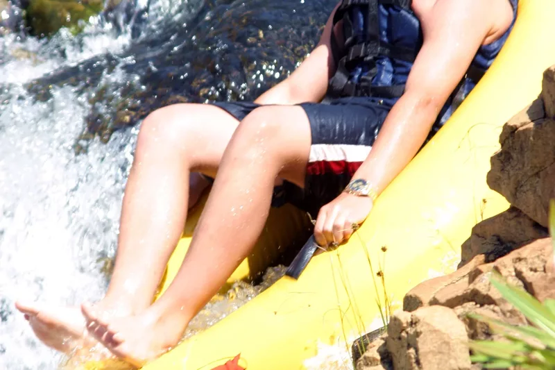 Young male gecko tubing in a river with Magoebaskloof Adventures