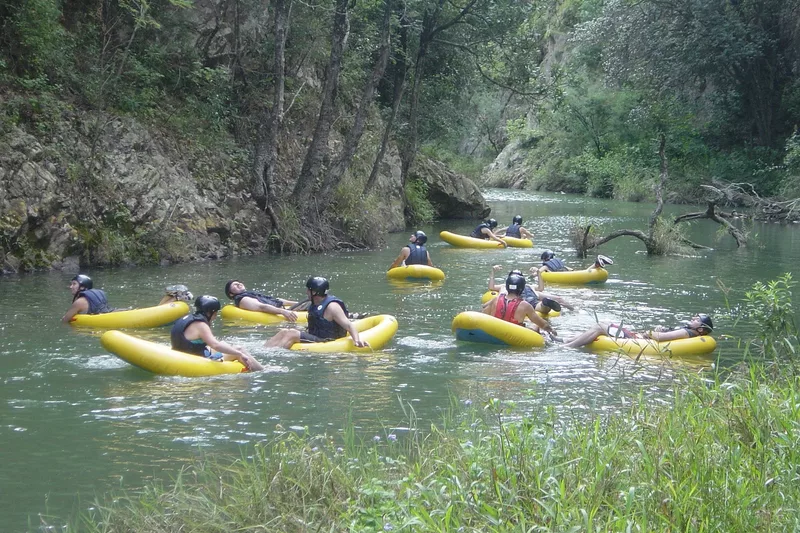 Group of tourists gecko tubing in a river with Magoebaskloof Adventures