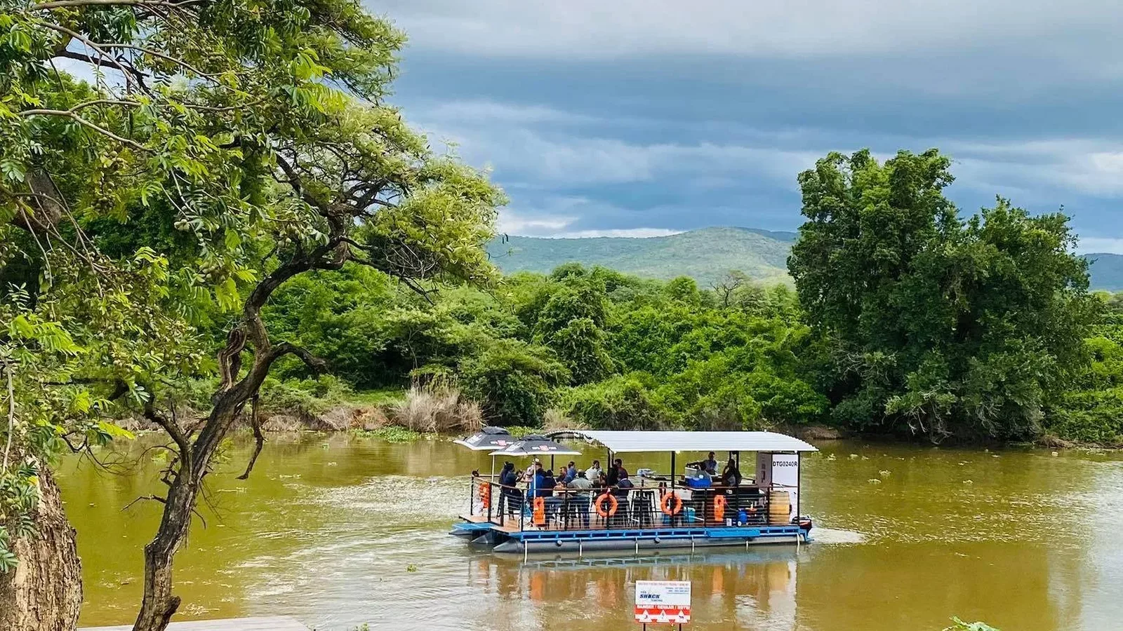 Tourists doing a boat cruise activity on the junction phoenix river boat in Tzaneen