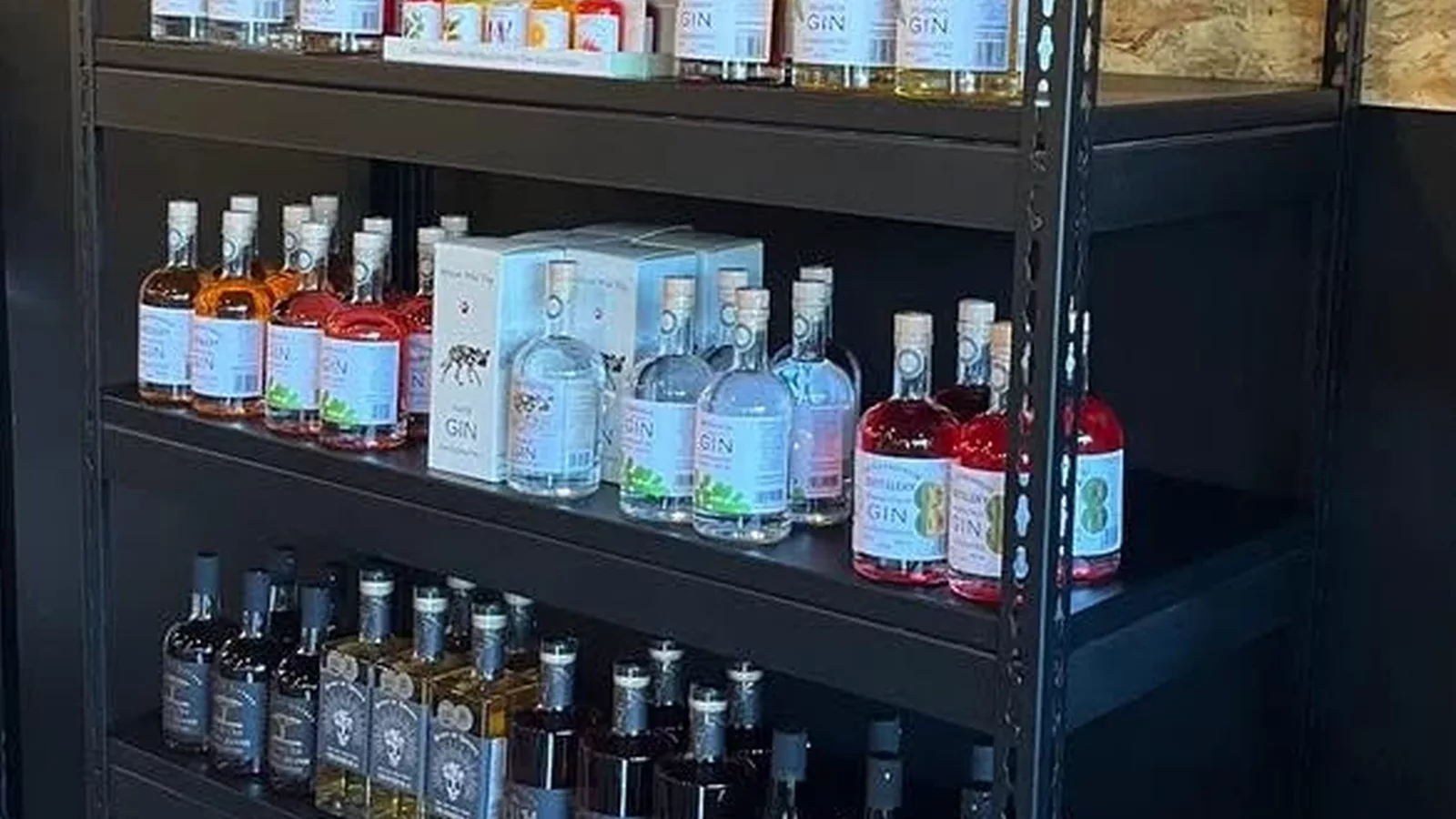 Gin bottles on shelf at old packhouse distillery near Tzaneen