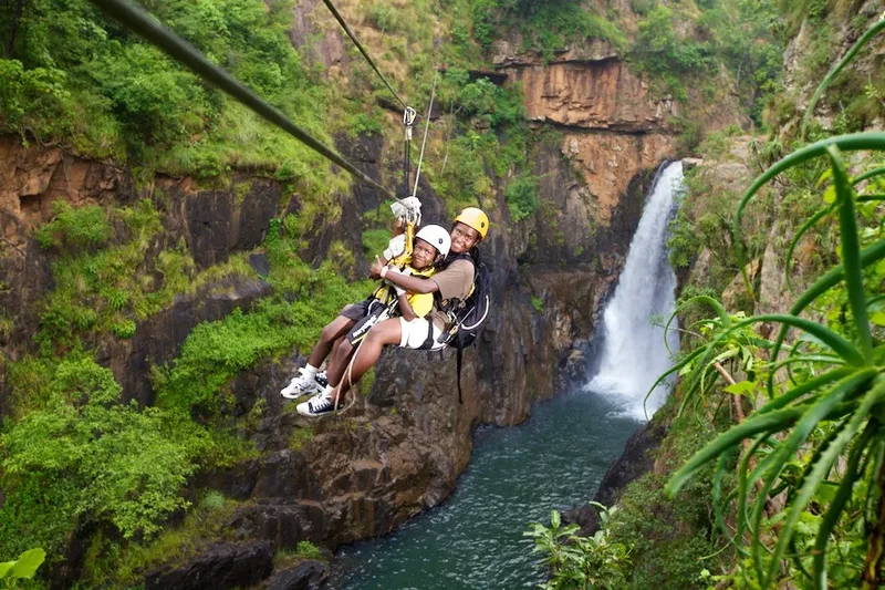 Two young tourists zip lining Magoebaskloof canopy tours in Tzaneen