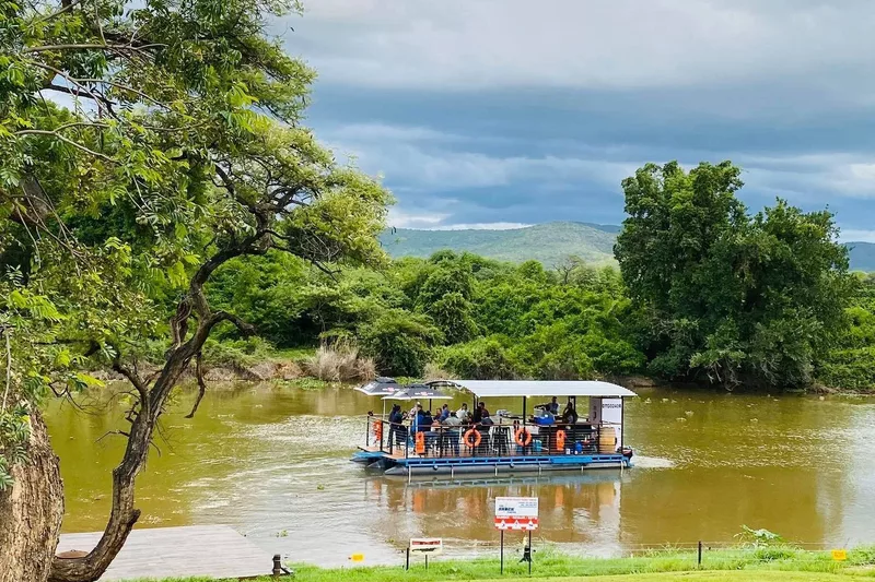 Tourists doing a boat cruise activity on the junction phoenix river boat in Tzaneen