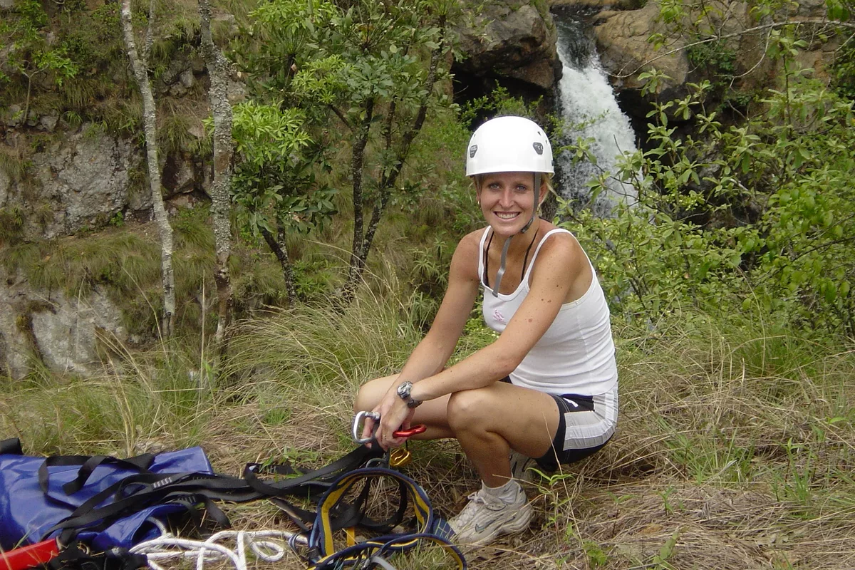 Female tourist posing after abseiling with Magoebaskloof Adventures in Tzaneen
