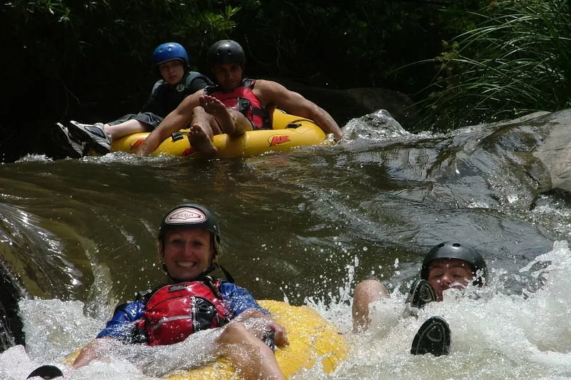 Tourists gecko tubing in a river with Magoebaskloof Adventures alternate view 2