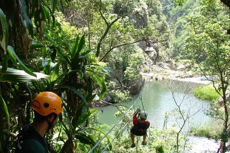 Two tourists zip lining Magoebaskloof canopy tours in Tzaneen