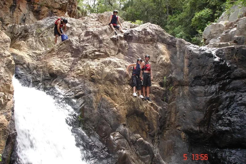 Young male tourists kloofing at Magoebaskloof in Tzaneen