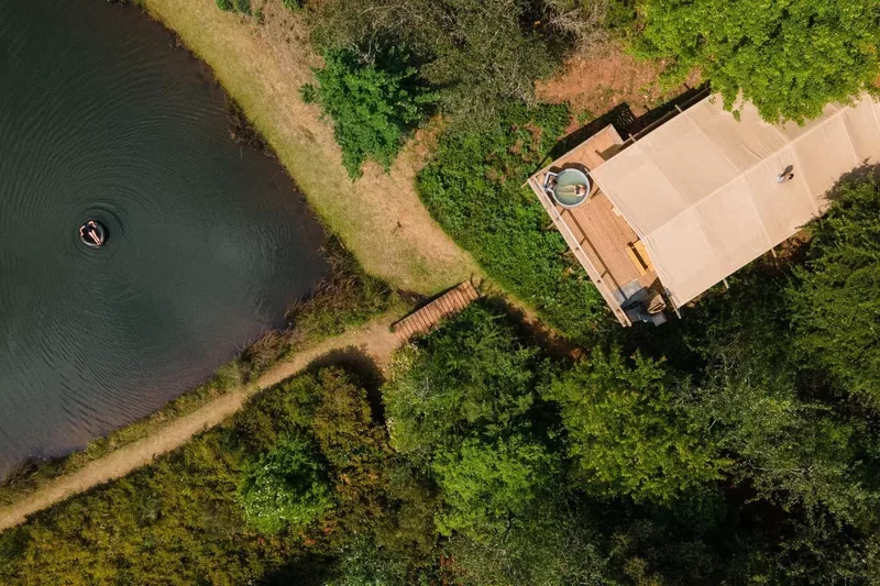 Aerial view of a cabin beside the dam at Cheerio Gardens in Magoebaskloof