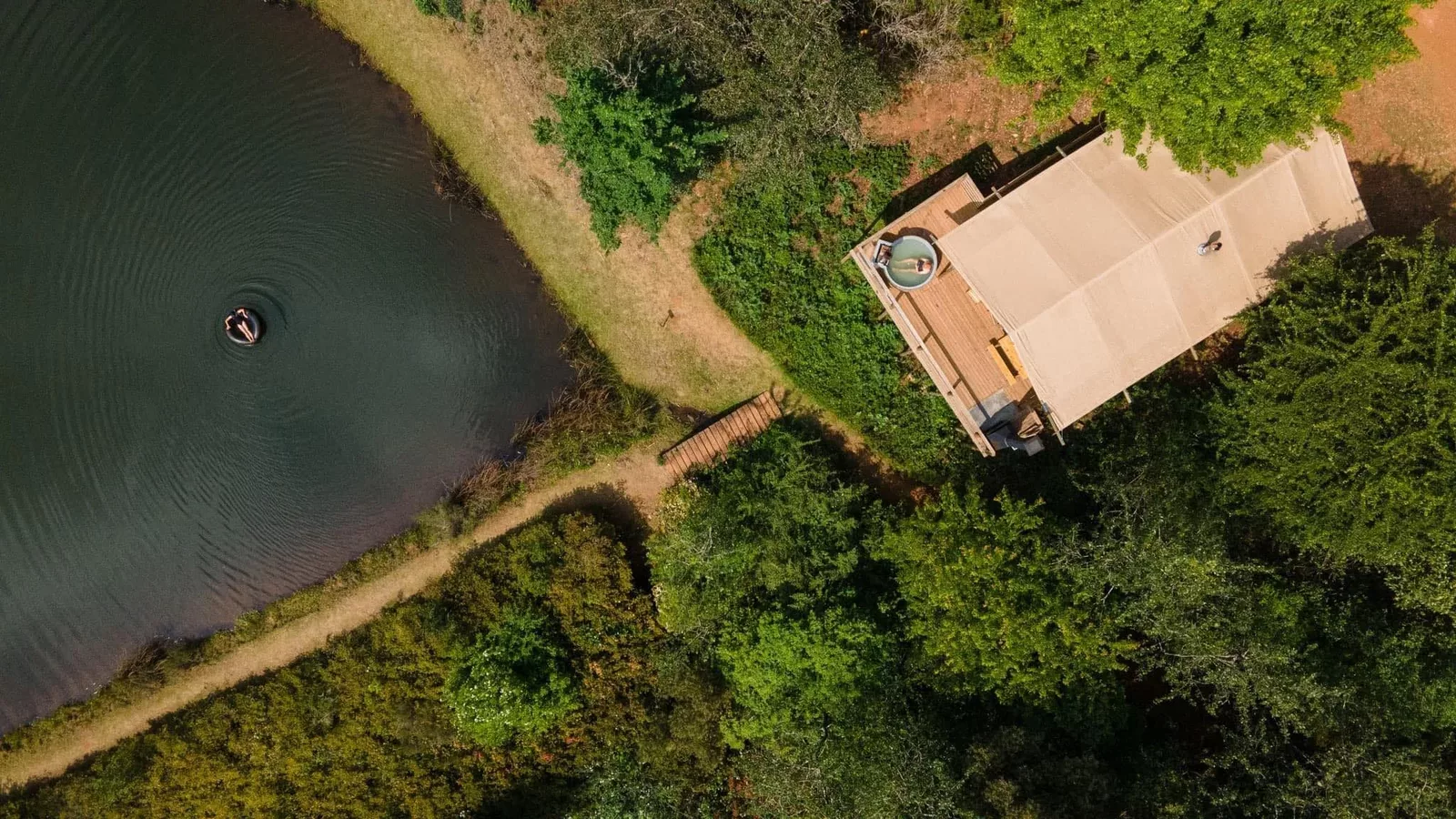 Aerial view of a cabin beside the dam at Cheerio Gardens in Magoebaskloof